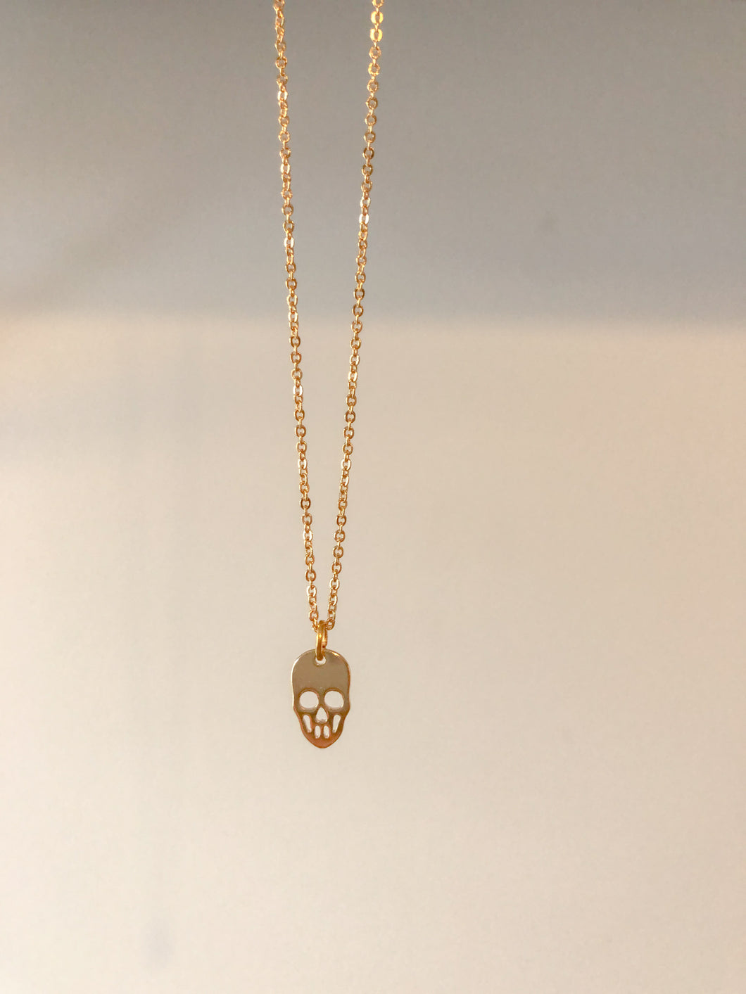 Gold mini skull necklace